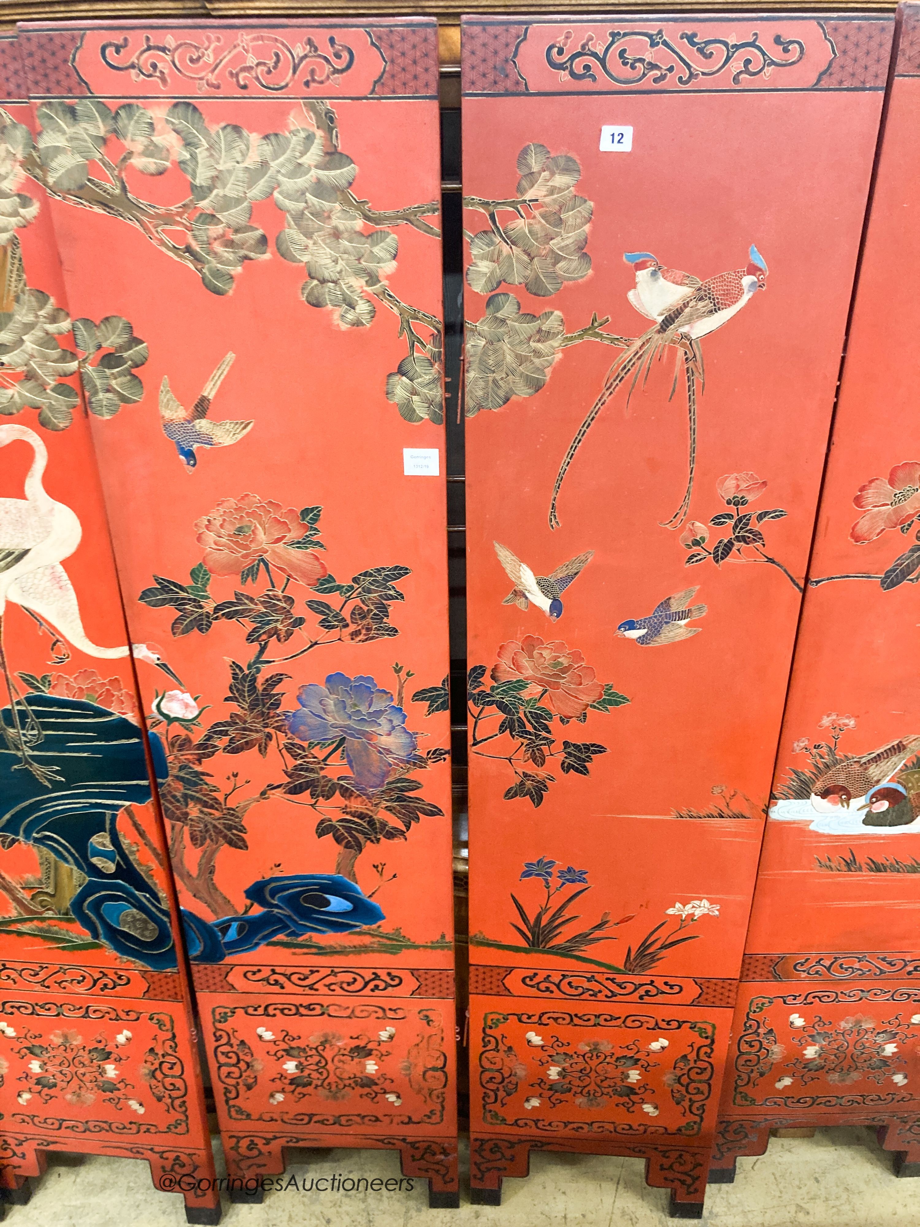 A Chinese red lacquered six fold screen, each panel W.41cm H.184cm